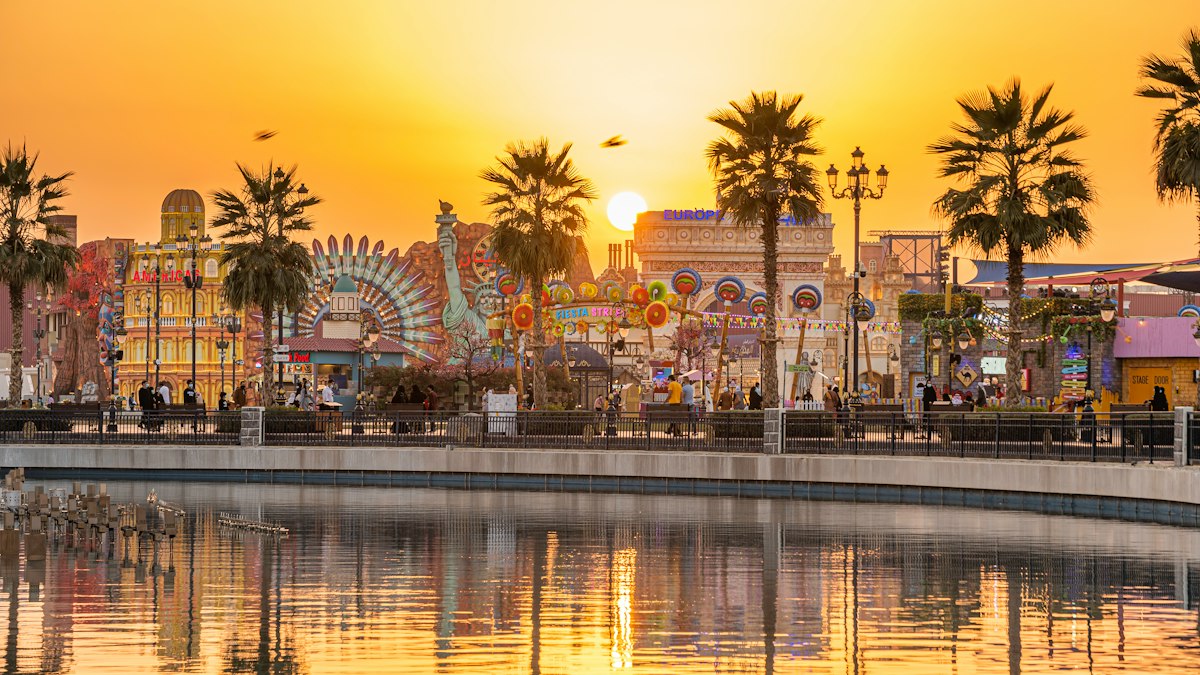 Global Village waterfront and illuminated pavilion buildings at sunset