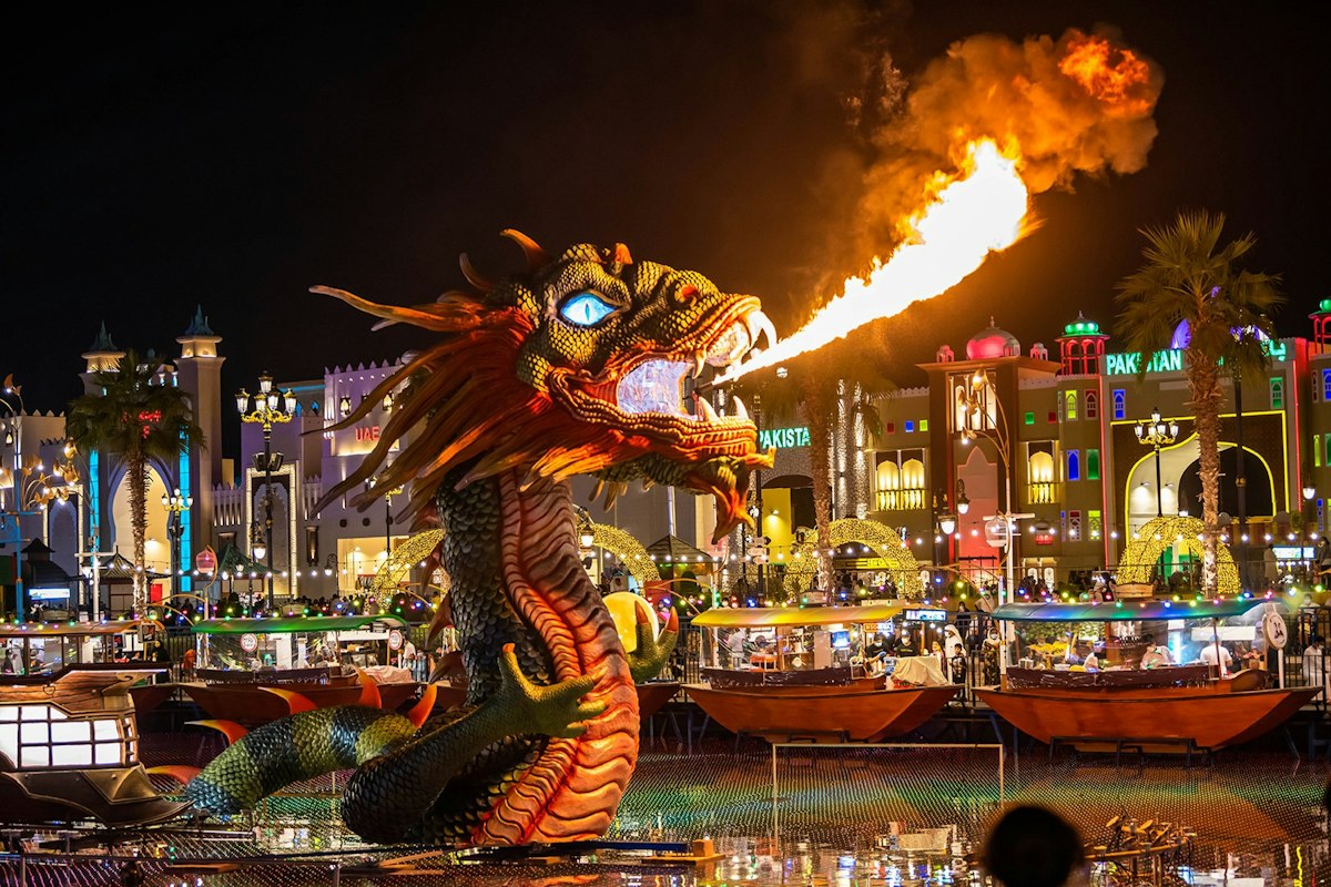 A illuminated dragon beside the Global Village waterfront